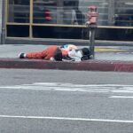 homeless man sleeping on a los angeles sidewalk